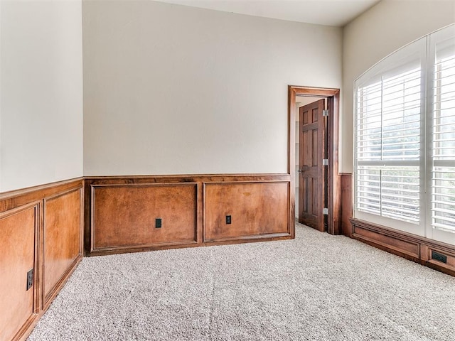 112 Lakeview Ct, Edmond, OK 73003 - carpeted empty room with wainscoting and a decorative wall