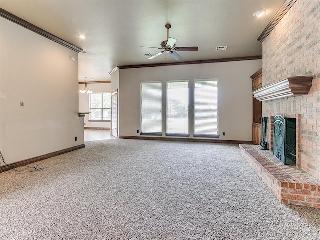 112 Lakeview Ct, Edmond, OK 73003 - unfurnished living room with crown molding, ceiling fan, light carpet, a brick fireplace, and a chandelier