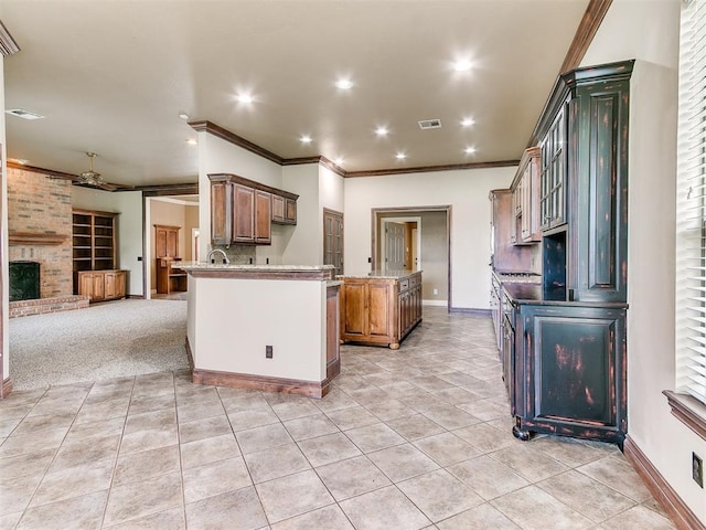 112 Lakeview Ct, Edmond, OK 73003 - kitchen with ornamental molding, light tile patterned floors, a fireplace, open floor plan, and recessed lighting