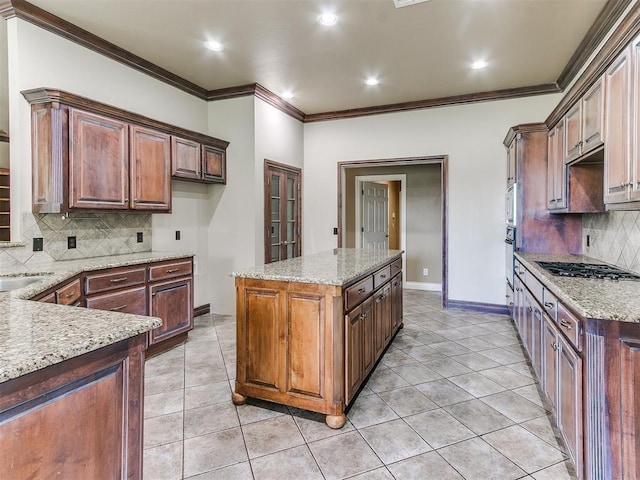 112 Lakeview Ct, Edmond, OK 73003 - kitchen with appliances with stainless steel finishes, tasteful backsplash, light stone counters, crown molding, and light tile patterned floors