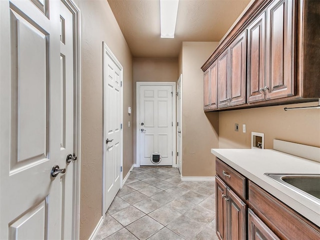 112 Lakeview Ct, Edmond, OK 73003 - laundry area featuring cabinet space, electric dryer hookup, washer hookup, and light tile patterned flooring