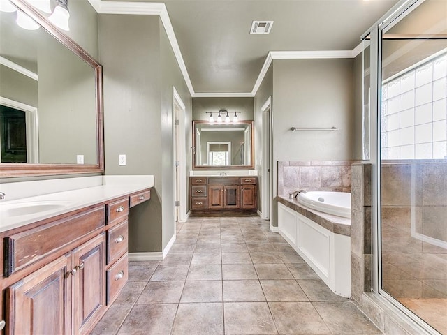 112 Lakeview Ct, Edmond, OK 73003 - full bathroom featuring two vanities, a garden tub, a stall shower, crown molding, and tile patterned floors