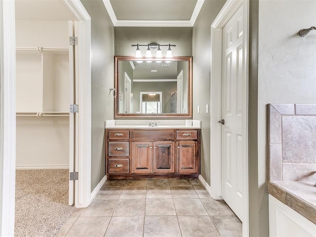 112 Lakeview Ct, Edmond, OK 73003 - bathroom with ornamental molding, vanity, a spacious closet, and tile patterned flooring