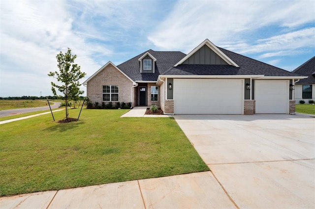 10400 SW 51st St, Mustang, OK 73064 - view of front of home featuring brick siding, a garage, a front yard, board and batten siding, and driveway