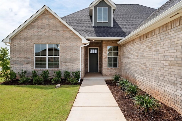 10400 SW 51st St, Mustang, OK 73064 - entrance to property with a lawn, brick siding, and a shingled roof