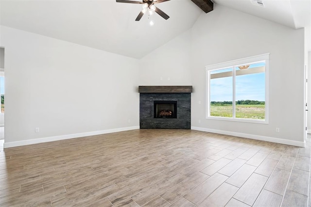 10400 SW 51st St, Mustang, OK 73064 - unfurnished living room with beam ceiling, high vaulted ceiling, ceiling fan, light wood-style floors, and a stone fireplace