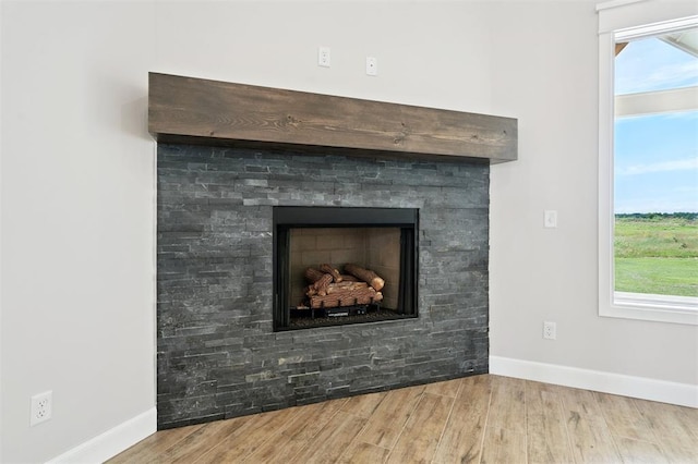10400 SW 51st St, Mustang, OK 73064 - detailed view of wood finished floors and a fireplace