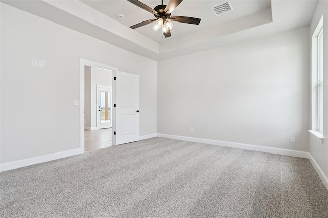 10400 SW 51st St, Mustang, OK 73064 - carpeted spare room featuring ceiling fan and a tray ceiling