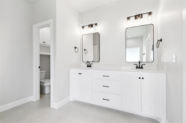10400 SW 51st St, Mustang, OK 73064 - bathroom featuring baseboards and double vanity