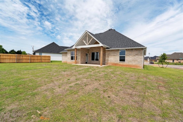 10400 SW 51st St, Mustang, OK 73064 - rear view of house with a patio, brick siding, and roof with shingles