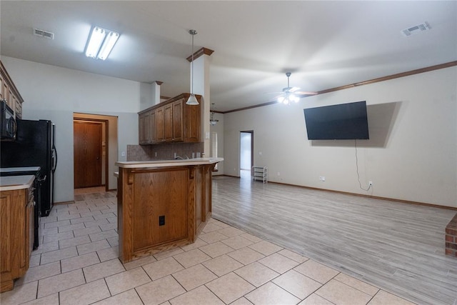 2728 SE 93rd St, Moore, OK 73160 - kitchen featuring a peninsula, open floor plan, light countertops, a ceiling fan, and ornamental molding