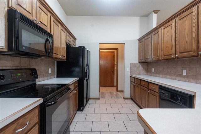 2728 SE 93rd St, Moore, OK 73160 - kitchen with black appliances, backsplash, light countertops, and brown cabinetry