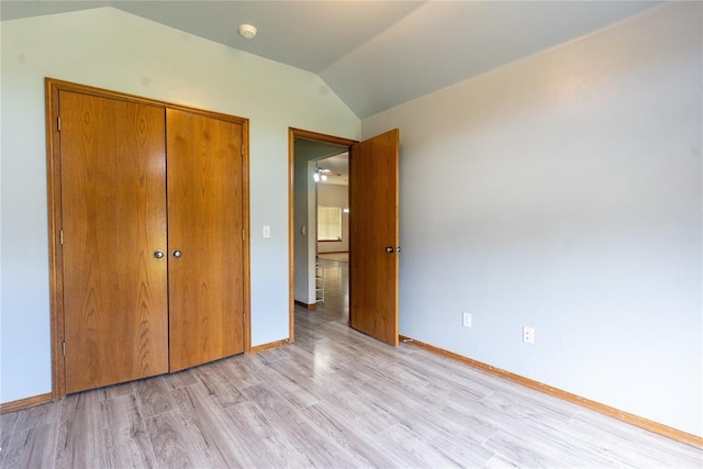 2728 SE 93rd St, Moore, OK 73160 - unfurnished bedroom with vaulted ceiling, a closet, and light wood-style flooring