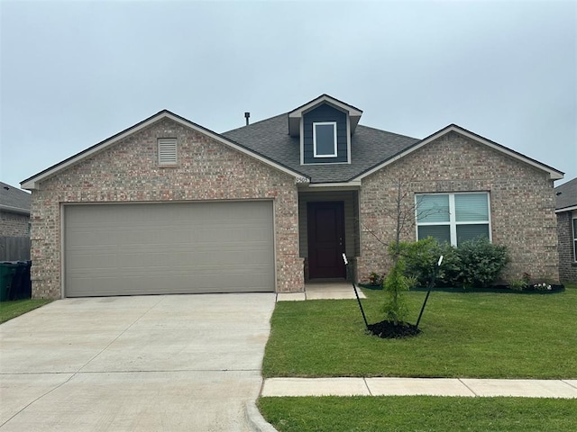 9505 Saddle Dr, Yukon, OK 73099 - view of front of house with brick siding, concrete driveway, a front lawn, and an attached garage