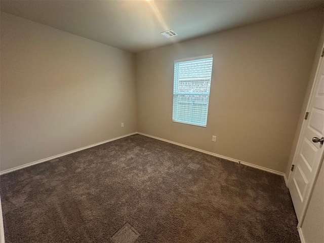 9505 Saddle Dr, Yukon, OK 73099 - empty room featuring dark colored carpet and baseboards