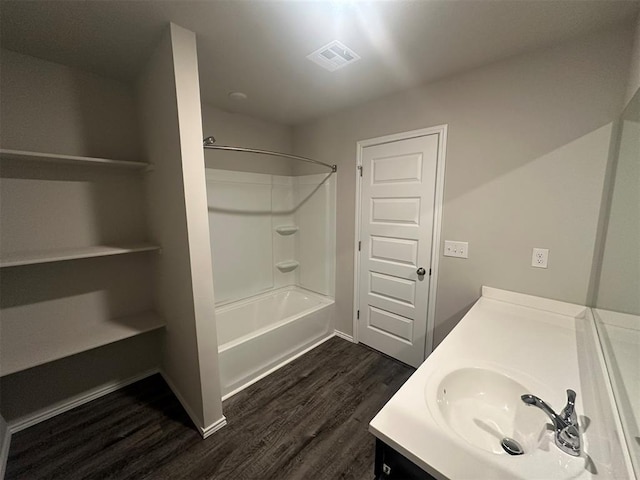 9505 Saddle Dr, Yukon, OK 73099 - bathroom featuring vanity, wood finished floors, and shower / washtub combination
