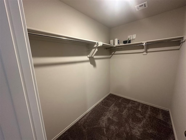 9505 Saddle Dr, Yukon, OK 73099 - spacious closet with dark colored carpet