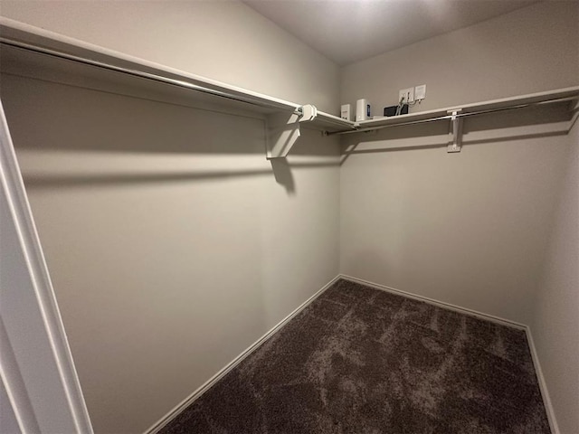 9505 Saddle Dr, Yukon, OK 73099 - walk in closet featuring dark colored carpet