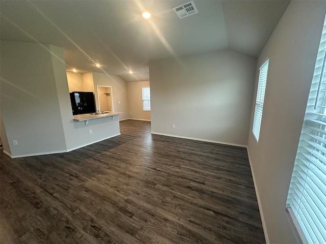 9505 Saddle Dr, Yukon, OK 73099 - unfurnished living room with lofted ceiling and dark wood-style floors