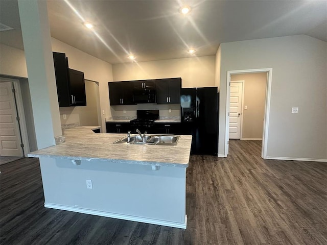 9505 Saddle Dr, Yukon, OK 73099 - kitchen with black appliances, dark cabinets, dark wood finished floors, a peninsula, and light countertops