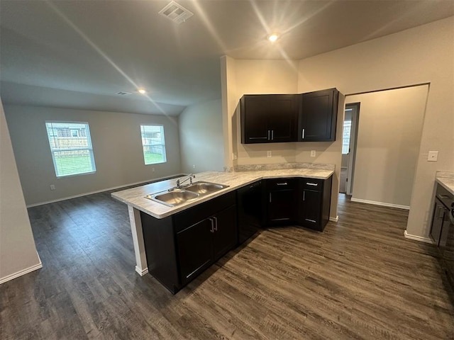 9505 Saddle Dr, Yukon, OK 73099 - kitchen with a peninsula, dark wood-type flooring, light countertops, open floor plan, and dark cabinets