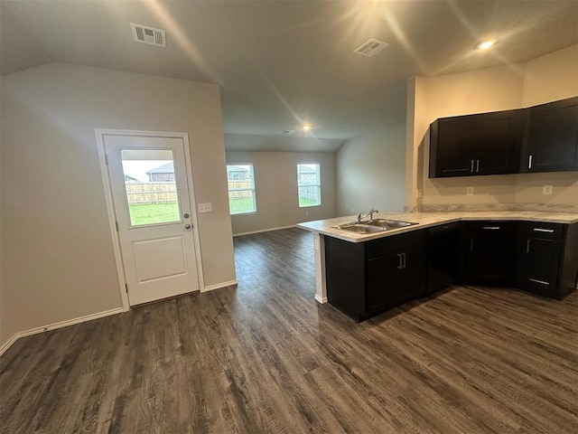 9505 Saddle Dr, Yukon, OK 73099 - kitchen with open floor plan, dark wood-type flooring, a peninsula, light countertops, and vaulted ceiling