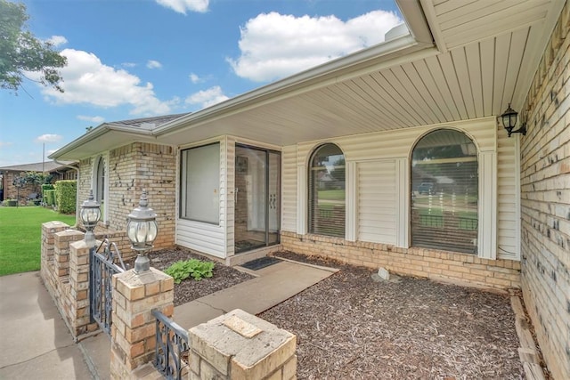 813 Tottingham Rd, Anadarko, OK 73005 - view of exterior entry with brick siding and covered porch
