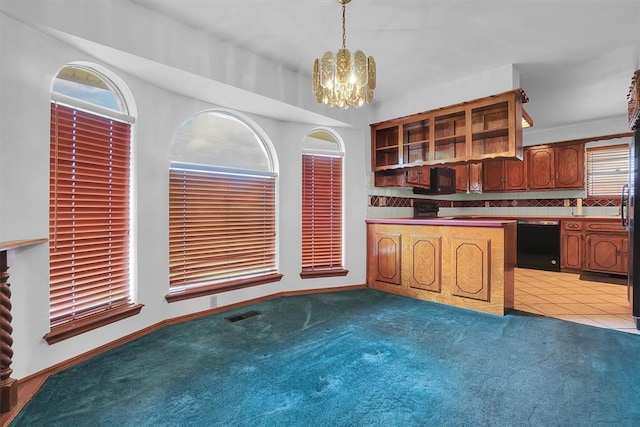 813 Tottingham Rd, Anadarko, OK 73005 - kitchen featuring dishwasher, a chandelier, carpet flooring, and backsplash
