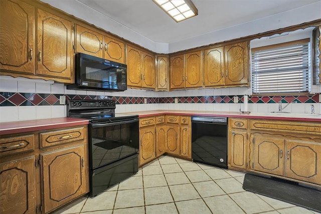 813 Tottingham Rd, Anadarko, OK 73005 - kitchen featuring black appliances, brown cabinetry, backsplash, and light tile patterned floors