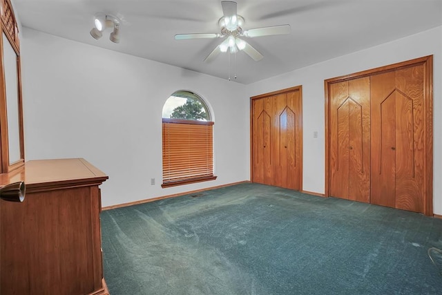 813 Tottingham Rd, Anadarko, OK 73005 - unfurnished bedroom featuring carpet floors, two closets, and ceiling fan
