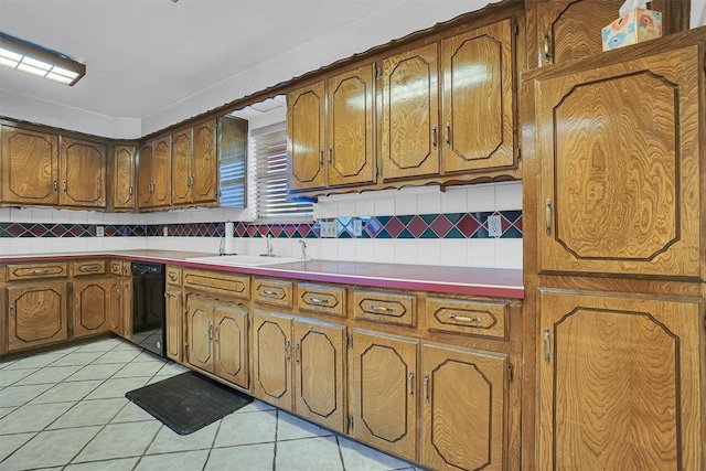 813 Tottingham Rd, Anadarko, OK 73005 - kitchen featuring dishwasher, tasteful backsplash, light tile patterned flooring, and brown cabinets