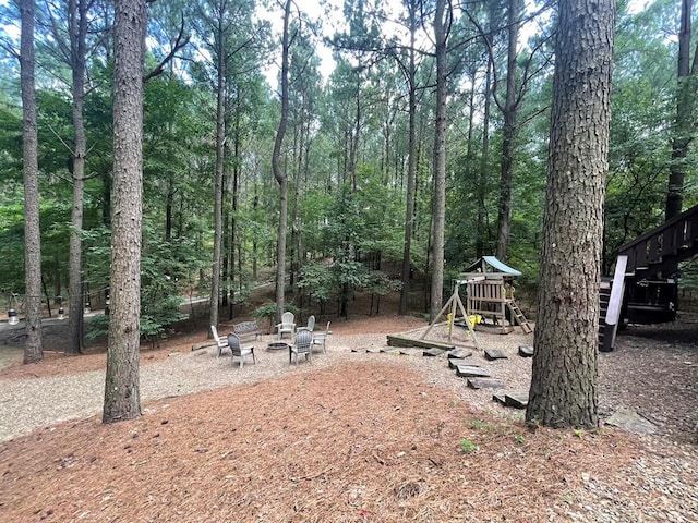 113 Bentwater Rd, Broken Bow, OK 74728 - view of yard with an outdoor fire pit, a playground, and stairway