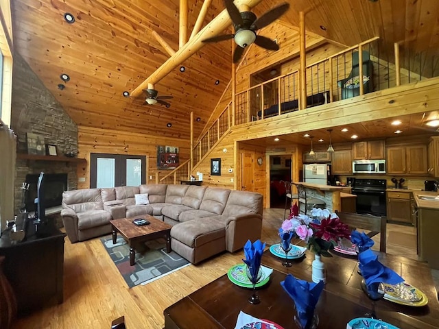 113 Bentwater Rd, Broken Bow, OK 74728 - living area with ceiling fan, high vaulted ceiling, wood ceiling, light wood-style floors, and wooden walls