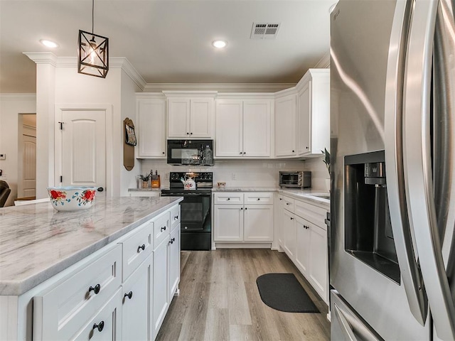 11712 Muirfield Ln, Guthrie, OK 73044 - kitchen featuring black appliances, white cabinets, ornamental molding, light wood-type flooring, and light stone counters