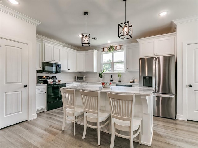 11712 Muirfield Ln, Guthrie, OK 73044 - kitchen featuring black appliances, ornamental molding, a center island, white cabinetry, and backsplash