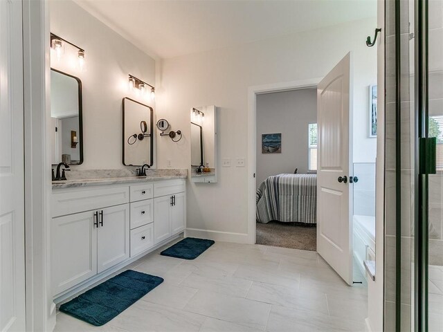 11712 Muirfield Ln, Guthrie, OK 73044 - full bathroom with connected bathroom, double vanity, and a bathtub