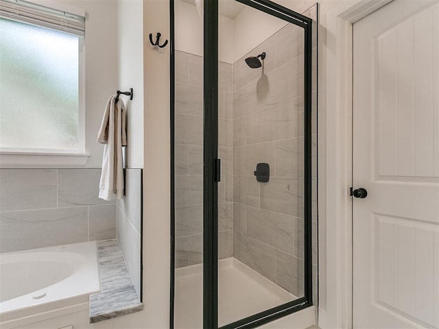 11712 Muirfield Ln, Guthrie, OK 73044 - bathroom featuring a shower stall, a bath, and plenty of natural light