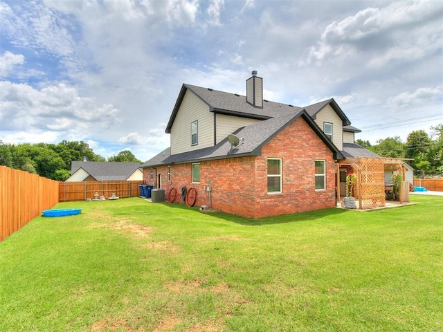 11712 Muirfield Ln, Guthrie, OK 73044 - rear view of property with a fenced backyard, a chimney, brick siding, and roof with shingles