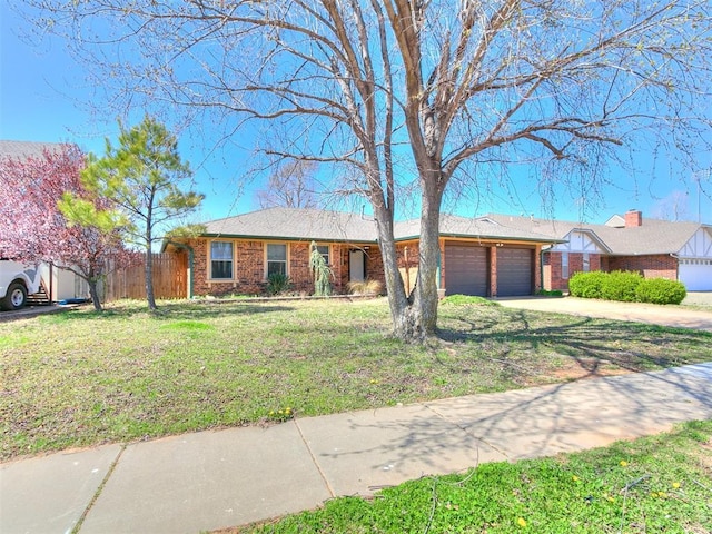 201 S Patterson Dr, Moore, OK 73160 - ranch-style home featuring a garage, driveway, and brick siding