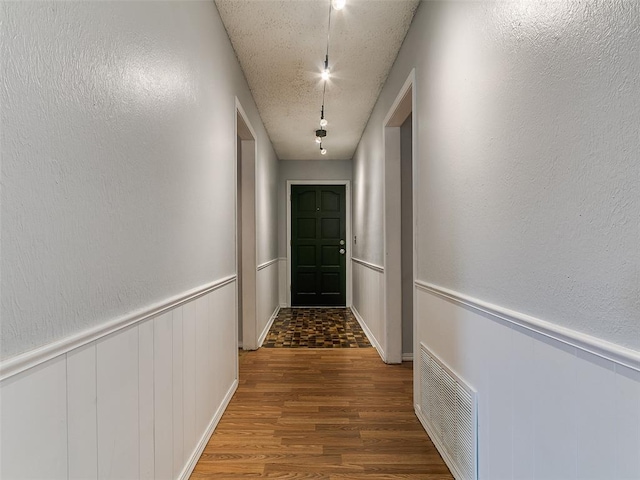 201 S Patterson Dr, Moore, OK 73160 - hall with wood finished floors, wainscoting, and a textured ceiling