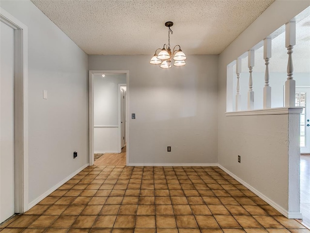 201 S Patterson Dr, Moore, OK 73160 - unfurnished room with a textured ceiling and a chandelier