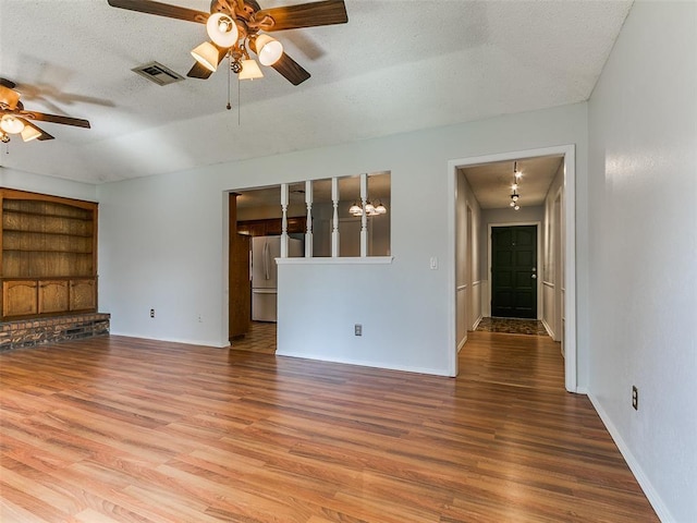 201 S Patterson Dr, Moore, OK 73160 - unfurnished living room featuring a ceiling fan, wood finished floors, and a textured ceiling