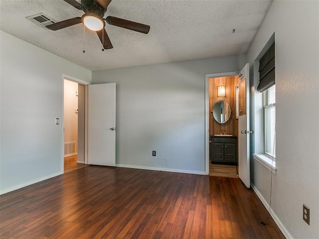 201 S Patterson Dr, Moore, OK 73160 - unfurnished bedroom with wood finished floors, a textured ceiling, connected bathroom, and a ceiling fan