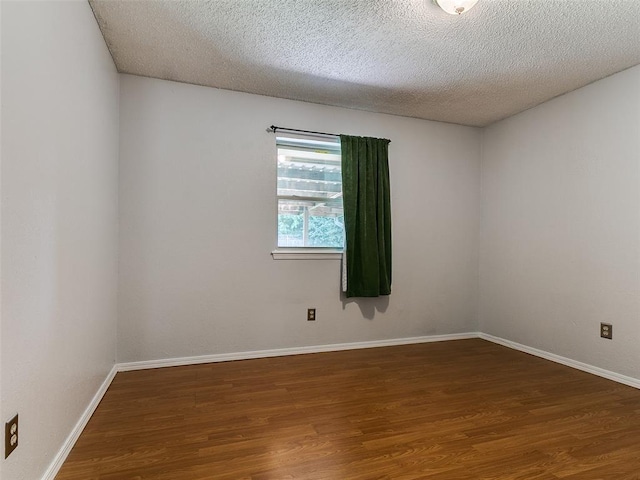 201 S Patterson Dr, Moore, OK 73160 - unfurnished room featuring wood finished floors and a textured ceiling