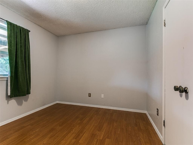 201 S Patterson Dr, Moore, OK 73160 - unfurnished room featuring wood finished floors and a textured ceiling