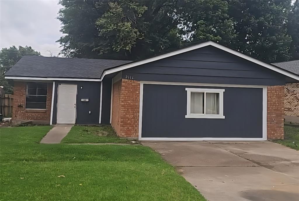 2112 N Wilburn Ave, Bethany, OK 73008 - view of front facade featuring brick siding, a front lawn, and concrete driveway
