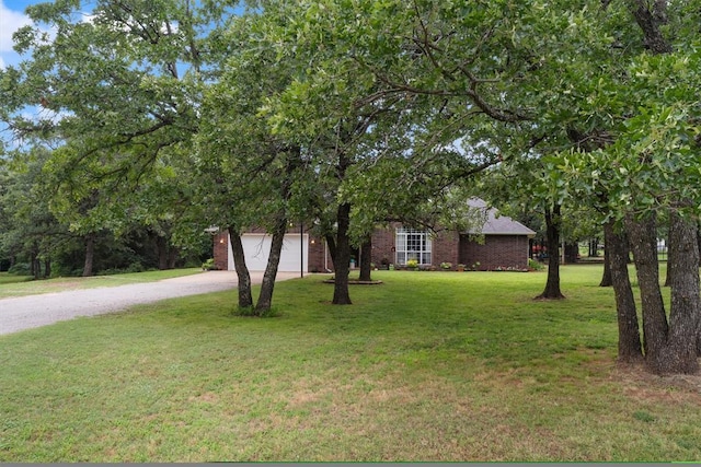 1748 Logans Run, Chandler, OK 74834 - view of property hidden behind natural elements with driveway, a front yard, brick siding, and an attached garage