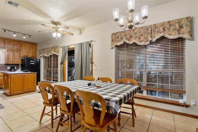 1748 Logans Run, Chandler, OK 74834 - dining room with light tile patterned floors, a ceiling fan, a chandelier, and track lighting