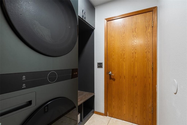 1748 Logans Run, Chandler, OK 74834 - laundry area with stacked washer and clothes dryer and light tile patterned floors