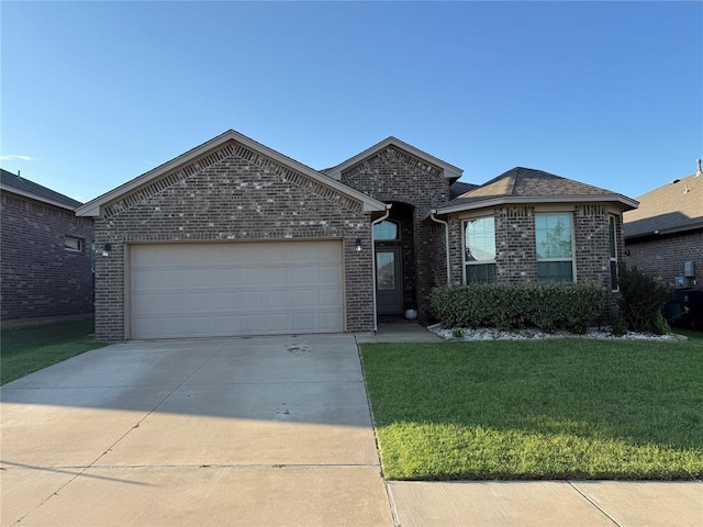11325 SW 33rd Ter, Yukon, OK 73099 - view of front facade featuring brick siding, a front yard, driveway, and an attached garage